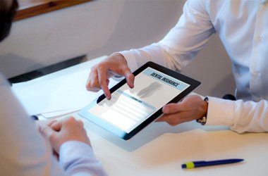 Patient and office manager reviewing dental insurance information